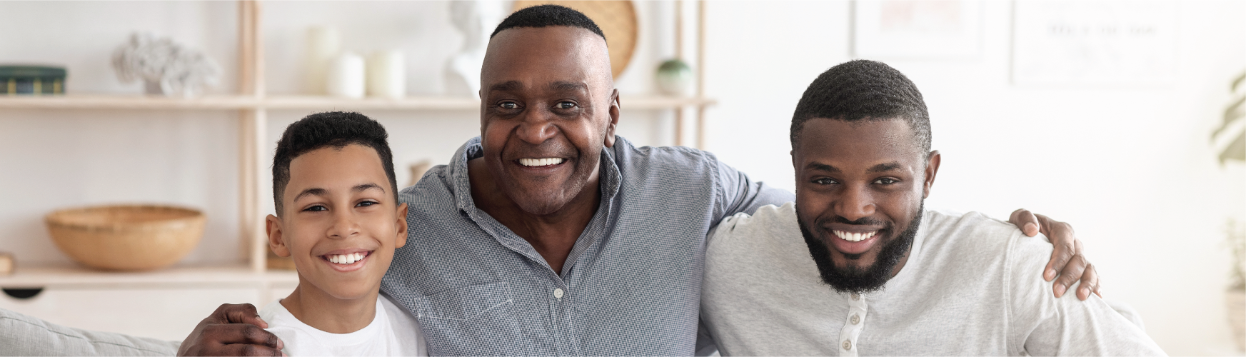 older man, younger man, and boy smiling
