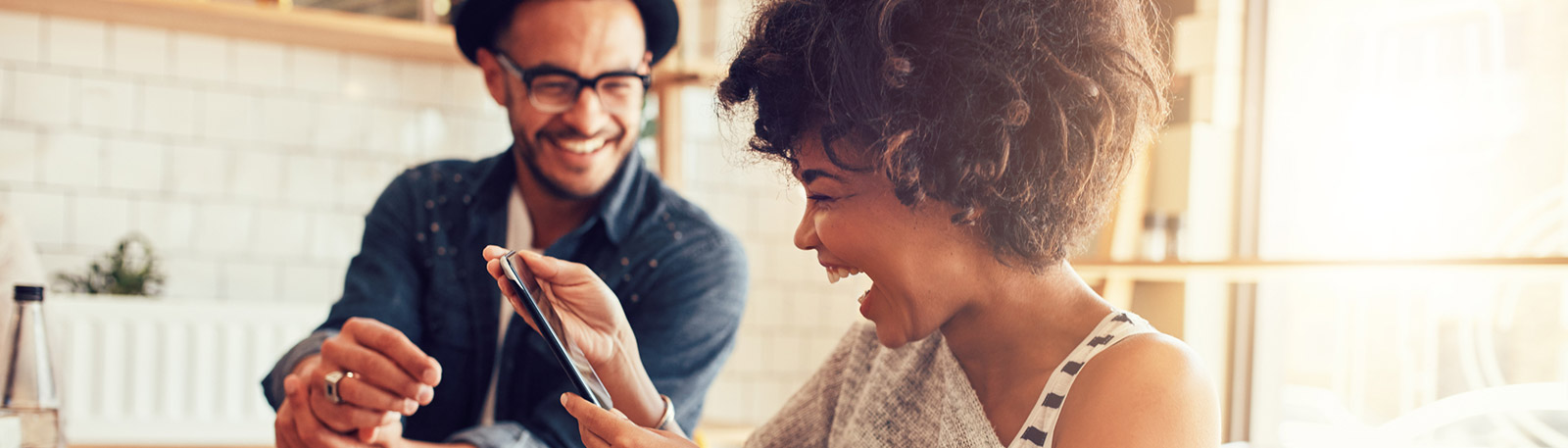 Couple using phone in kitchen