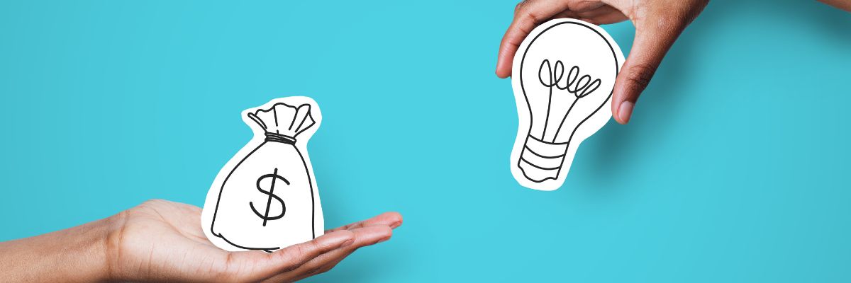 hands holding graphic of lightbulb and cash