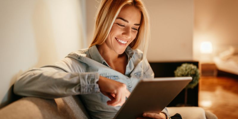 woman smiling at tablet
