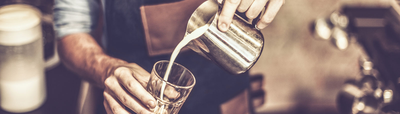 Close up of hands pouring coffee