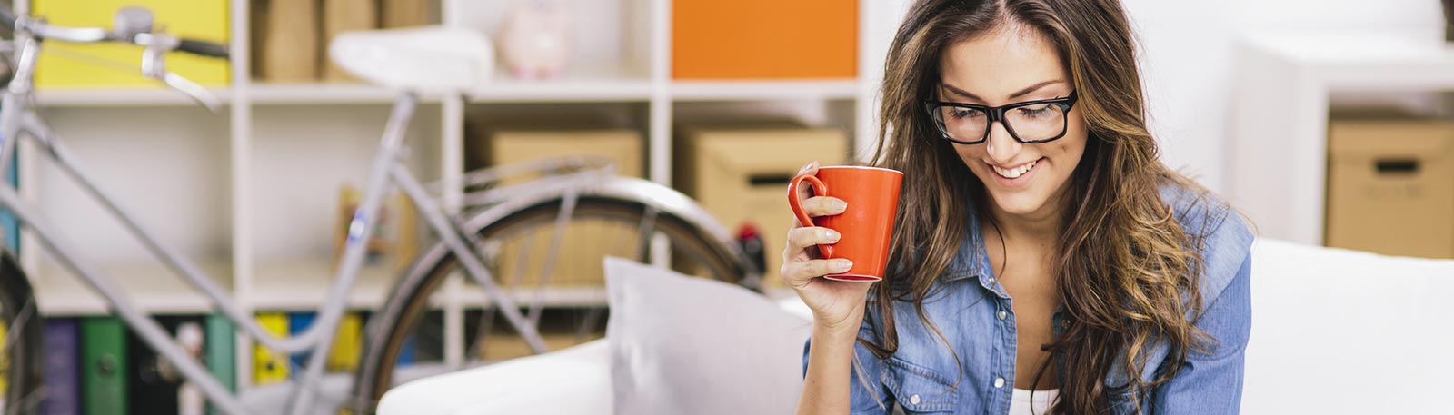 Woman drinking coffee in living room