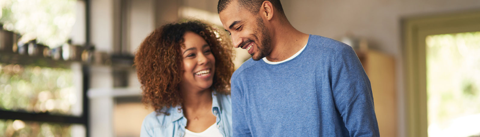 Young couple laughing in kitchen